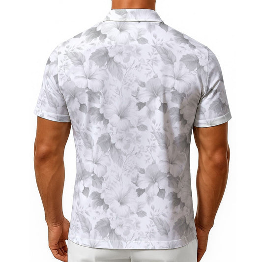 A man viewed from the back wearing a short-sleeve polo shirt with a white and gray floral print, paired with white pants, against a plain white background.