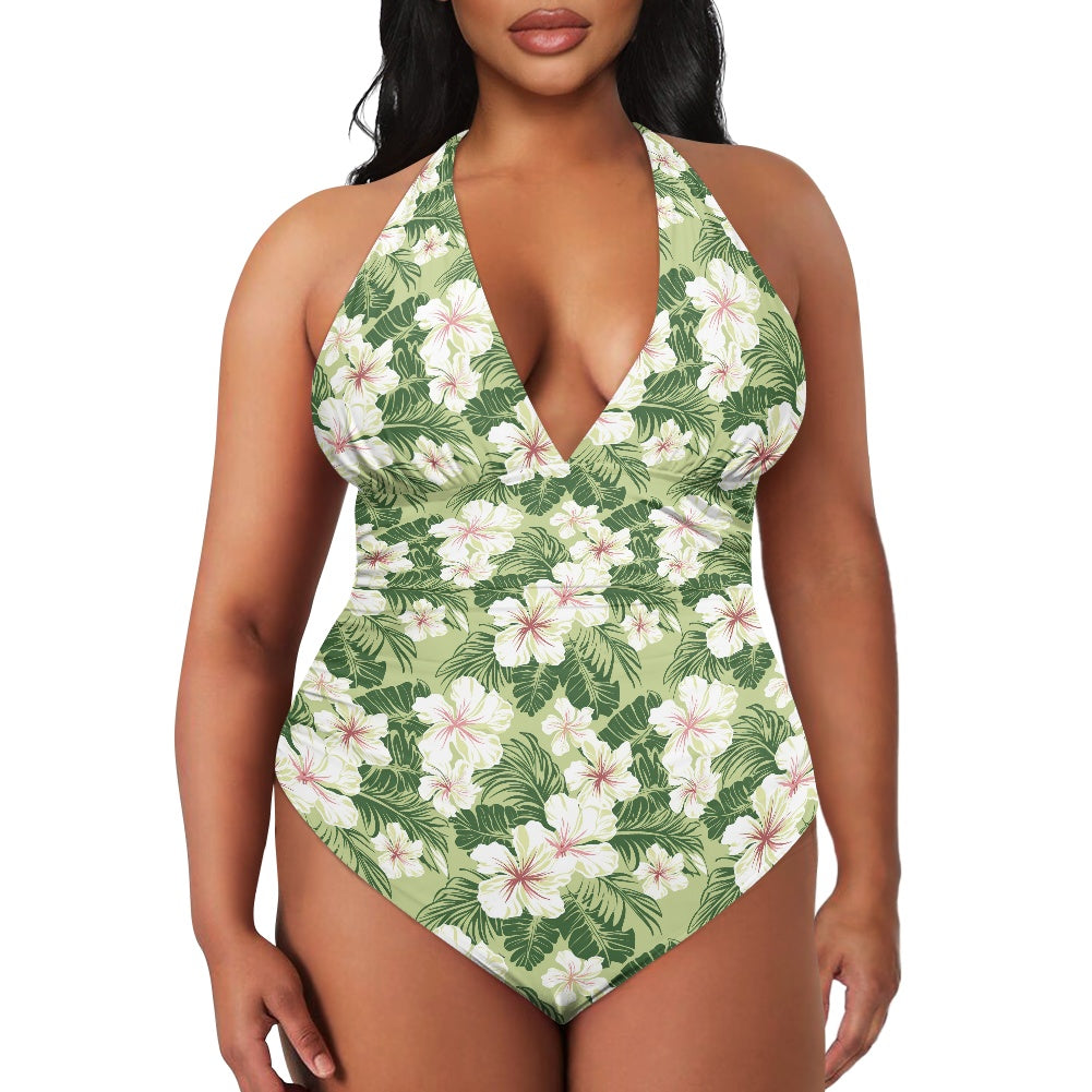 Tropical floral one-piece swimsuit on a model against a white background