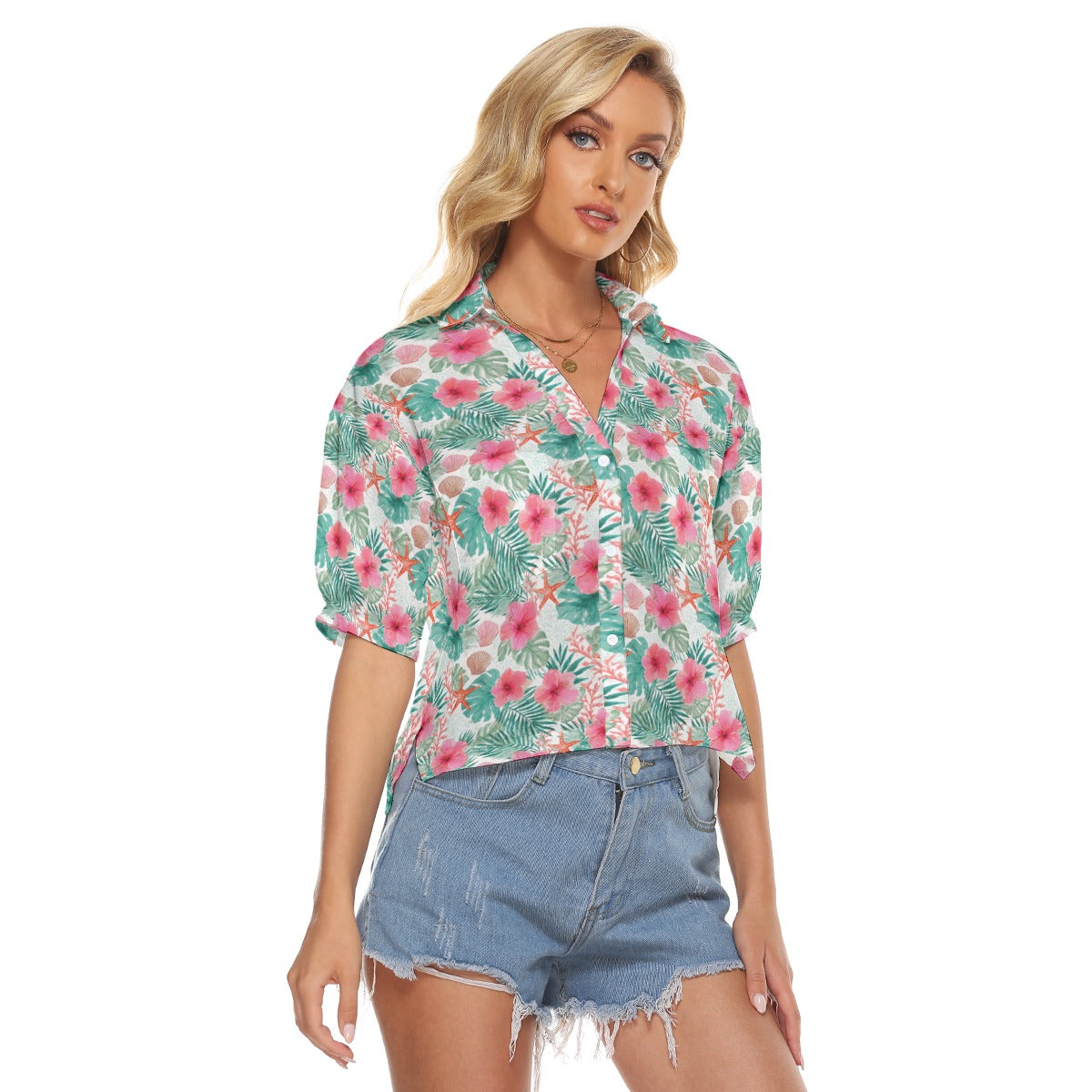 Woman wearing a floral blouse and denim shorts on a white background