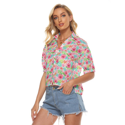 Woman wearing a colorful floral blouse and denim shorts on a white background