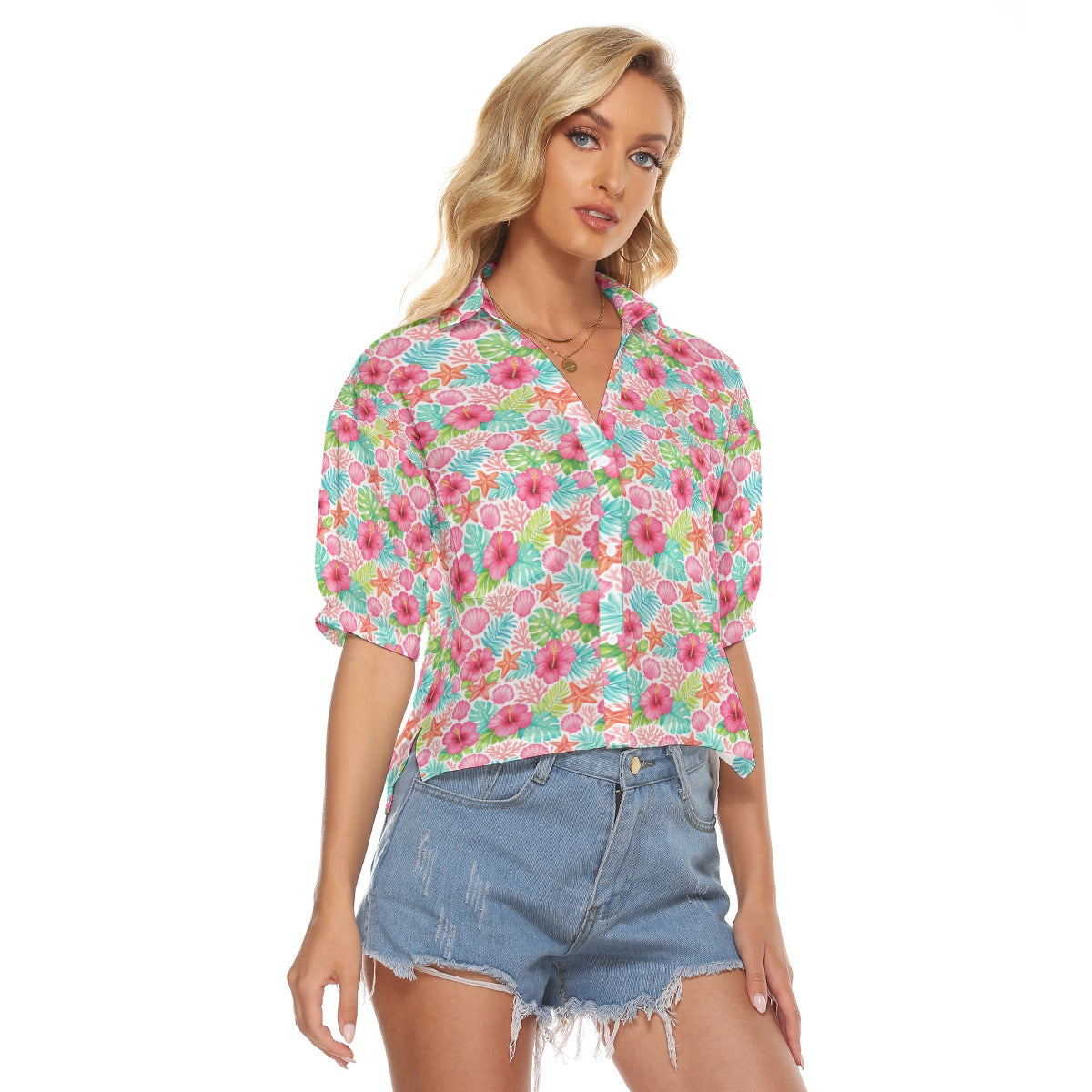 Woman wearing a colorful floral blouse and denim shorts on a white background